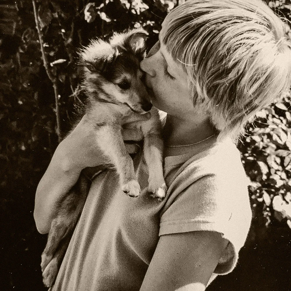 Sally as a child, holding her first puppy